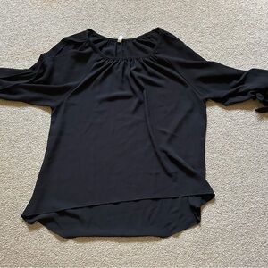 Black 3/4 blouse with ties around the wrist and partially open arms. Super cute!